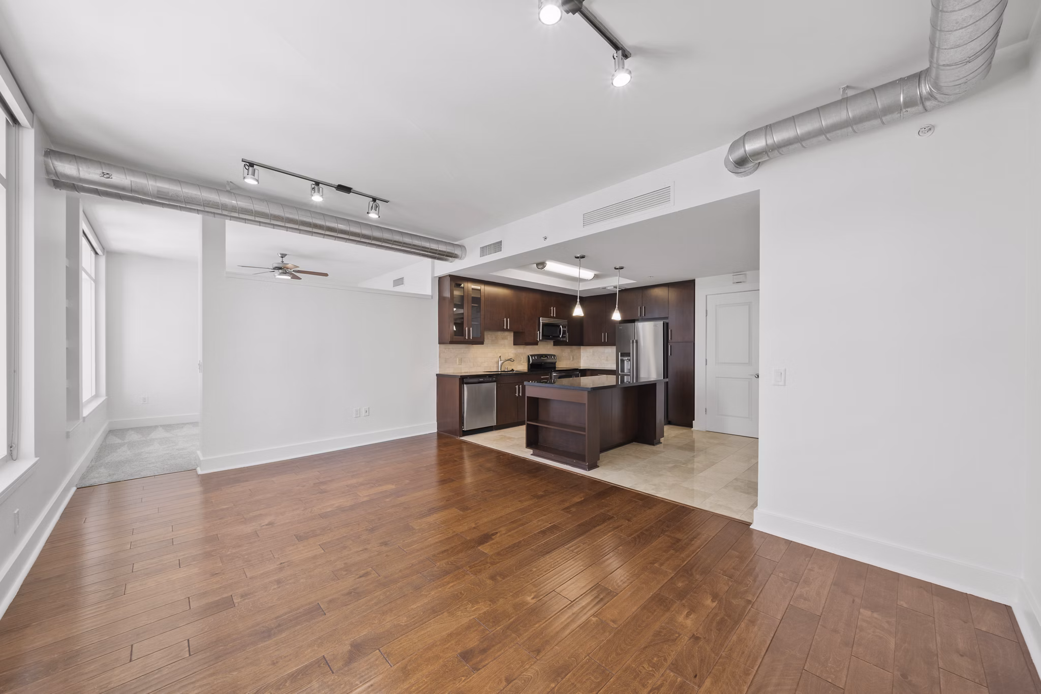 Kitchen featuring modern appliances and sleek countertops at 717 Olympic Apartments in Los Angeles