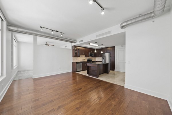 Kitchen featuring modern appliances and sleek countertops at 717 Olympic Apartments in Los Angeles