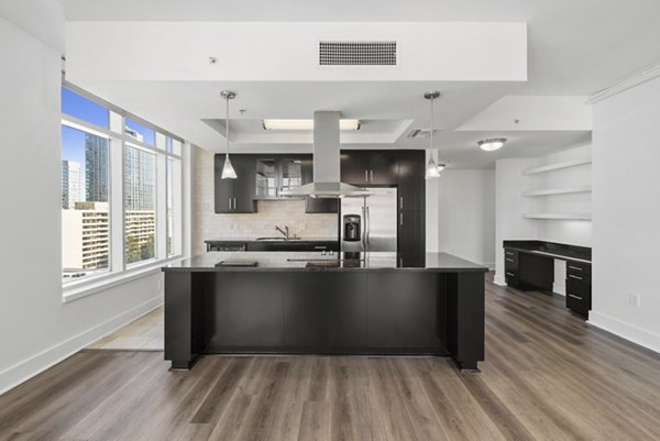 Kitchen featuring modern appliances and sleek design at 717 Olympic Apartments in luxury Greystar community