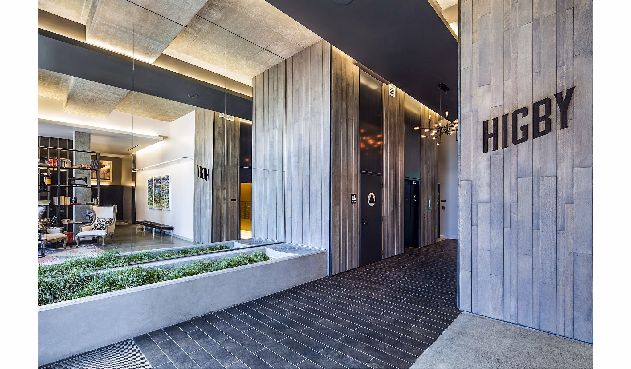 Higby Apartments: Modern clubhouse lobby featuring stylish seating and contemporary decor