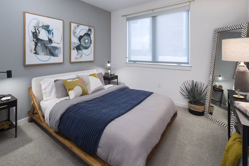 Cozy bedroom featuring modern decor in Alexan Diagonal Crossing Apartments
