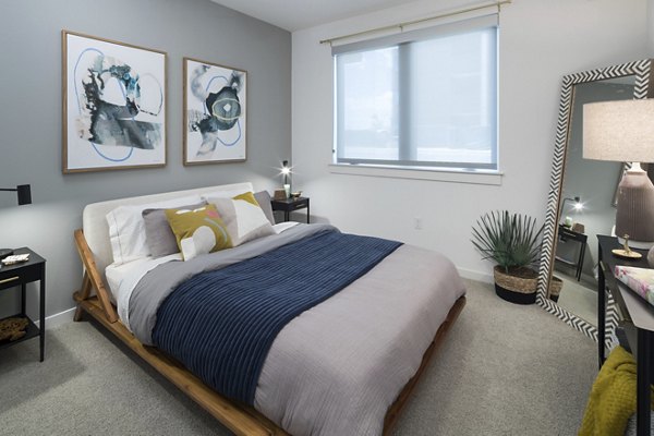 Cozy bedroom featuring modern decor in Alexan Diagonal Crossing Apartments