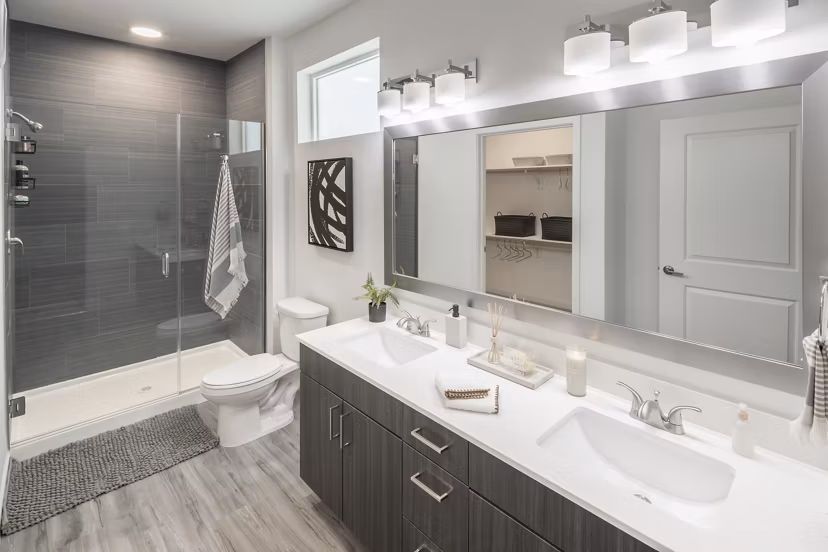 Modern bathroom with sleek fixtures and ample lighting at Alexan Diagonal Crossing Apartments