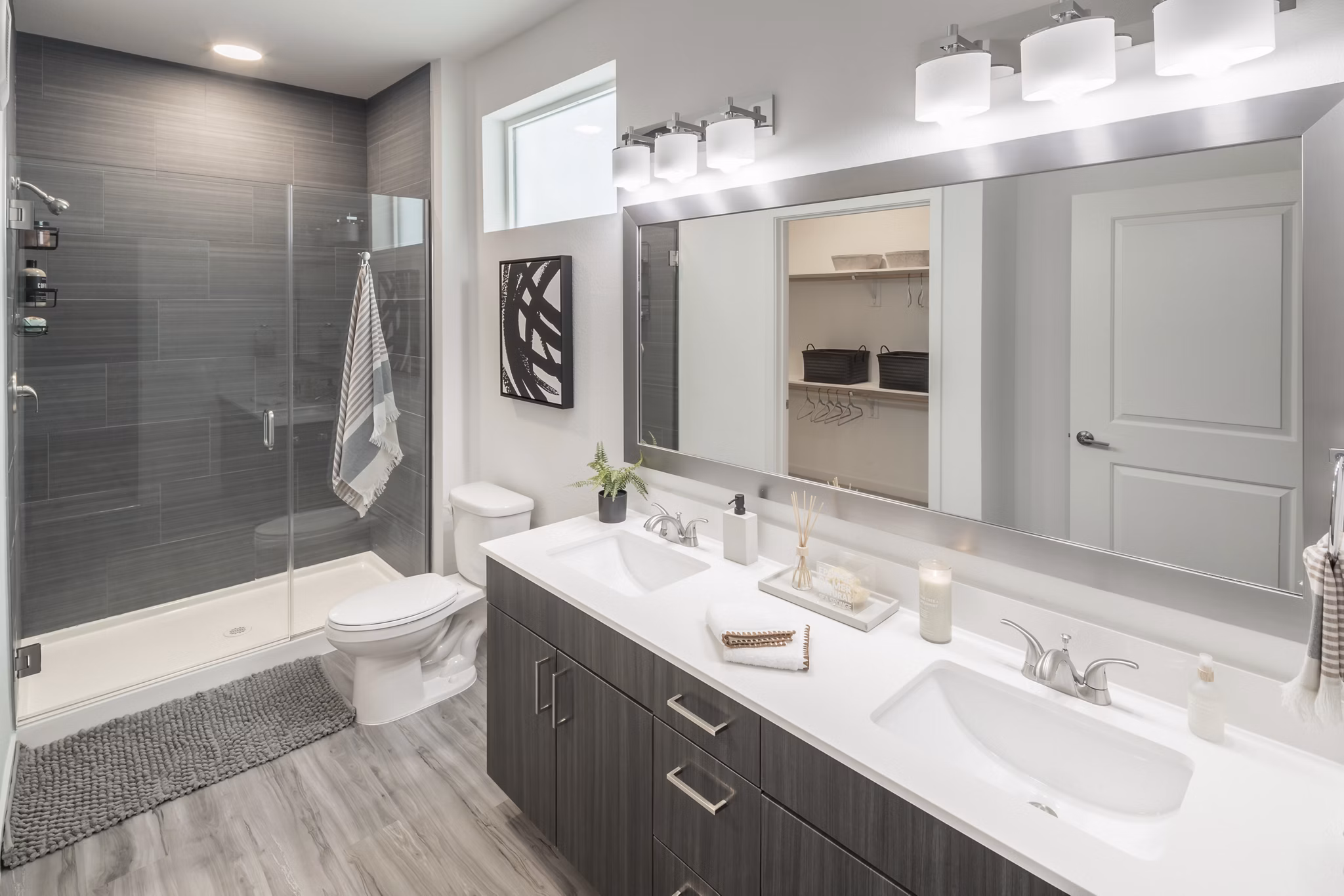 Modern bathroom with sleek fixtures and ample lighting at Alexan Diagonal Crossing Apartments