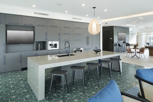 Modern clubhouse with cozy seating and large windows at Alexan Diagonal Crossing Apartments