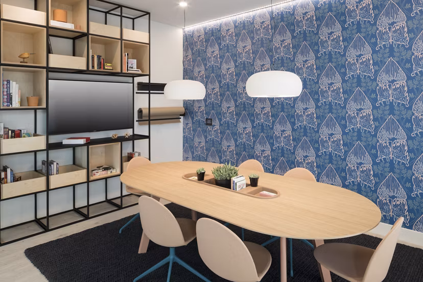 Modern meeting facility with advanced tech and seating at Alexan Diagonal Crossing Apartments, ideal for business gatherings and conferences