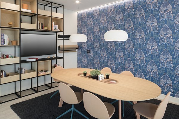 Modern meeting facility with advanced tech and seating at Alexan Diagonal Crossing Apartments, ideal for business gatherings and conferences