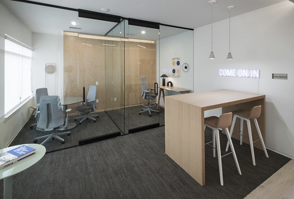 Clubhouse with modern design and comfortable seating at Alexan Diagonal Crossing Apartments, a luxury property by Greystar