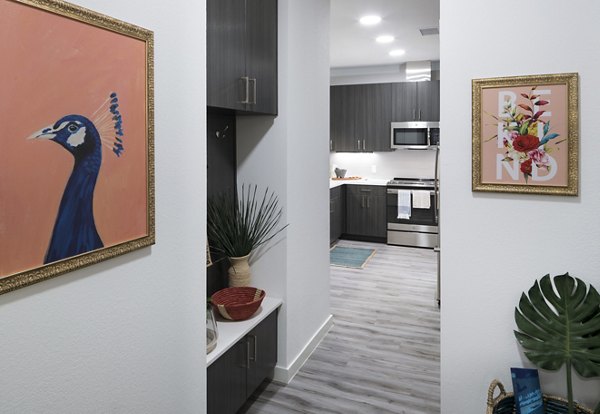 Hallway featuring modern lighting and artwork in Alexan Diagonal Crossing Apartments