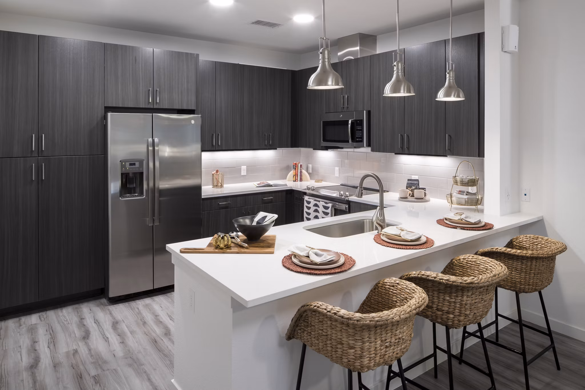 Modern kitchen with stainless steel appliances at Alexan Diagonal Crossing Apartments