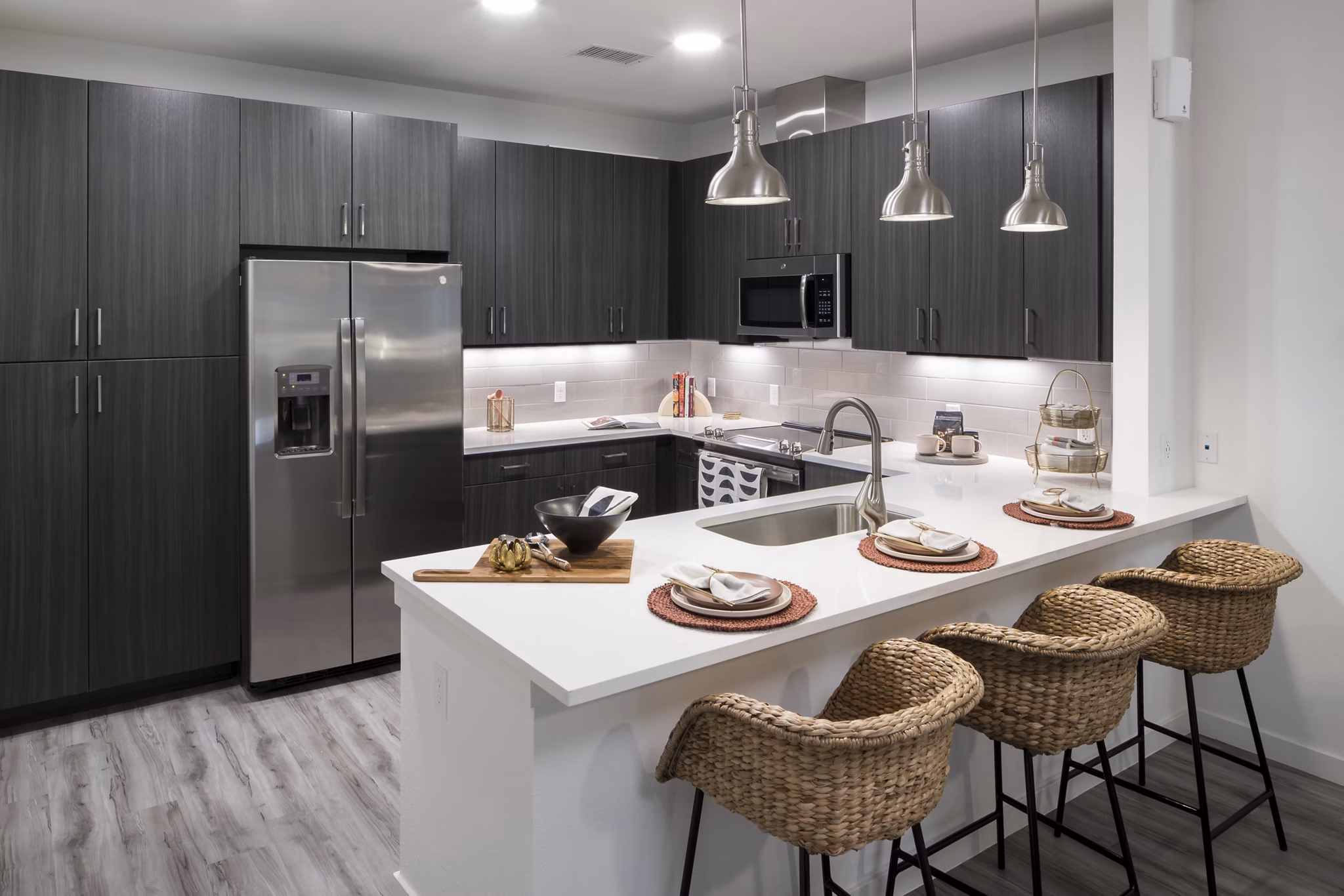 Modern kitchen with stainless steel appliances at Alexan Diagonal Crossing Apartments