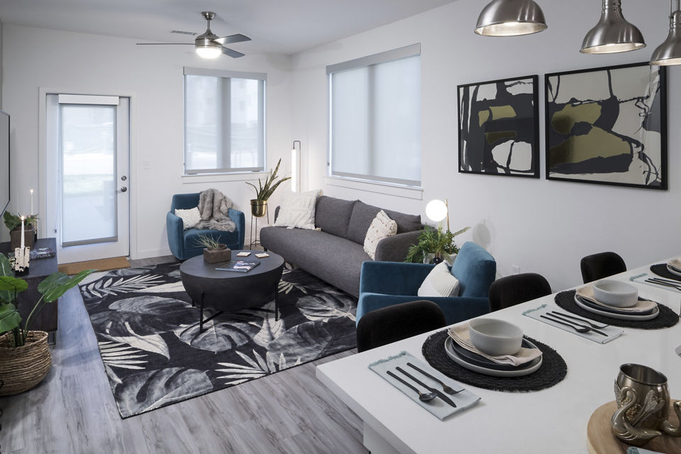 Spacious living room with minimalist design in Alexan Diagonal Crossing Apartments