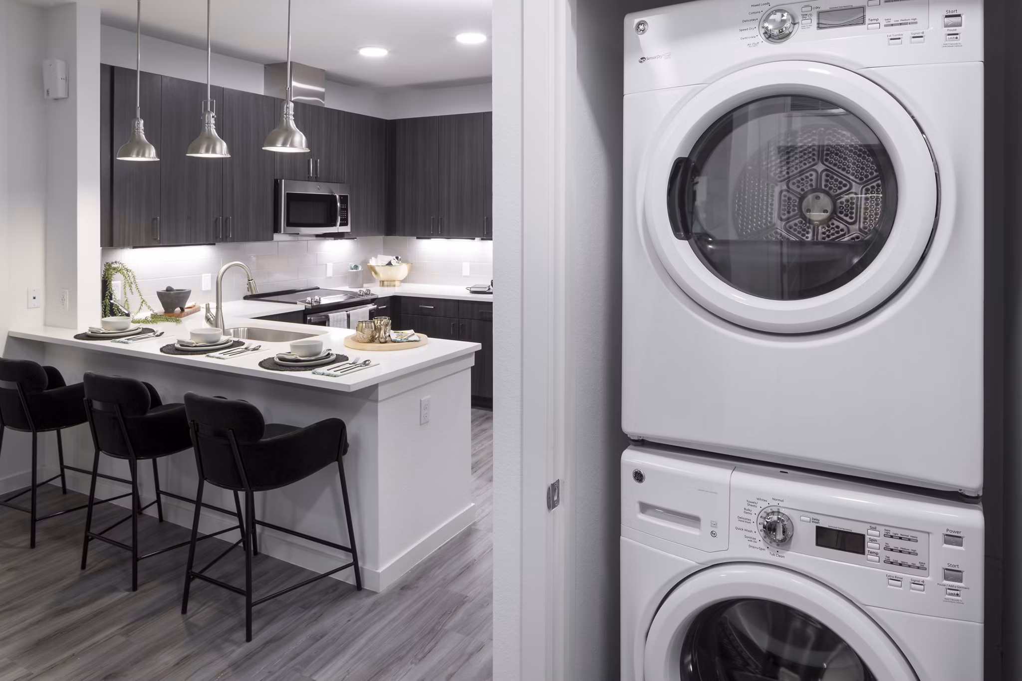 Laundry room with energy-efficient washers and dryers at Alexan Diagonal Crossing Apartments