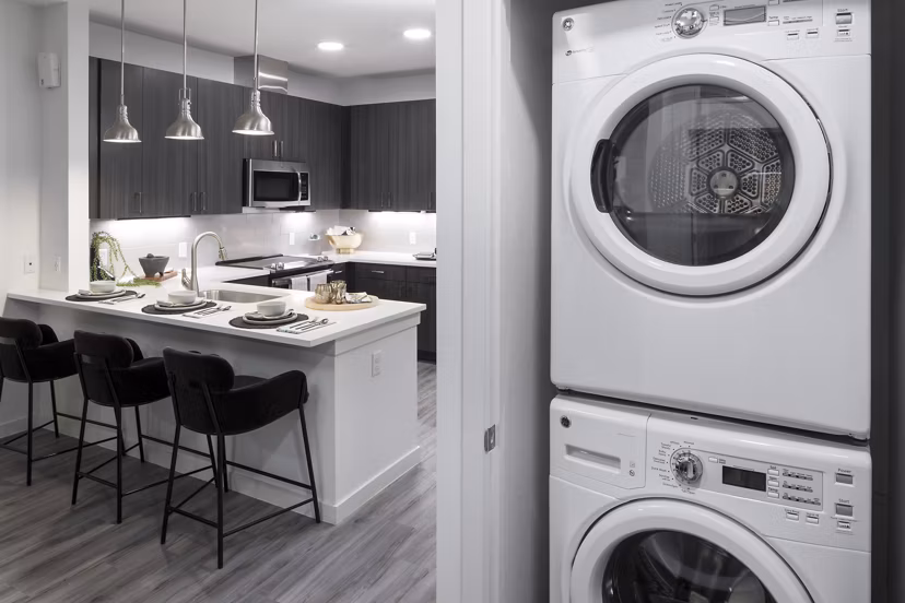 Laundry room with energy-efficient washers and dryers at Alexan Diagonal Crossing Apartments