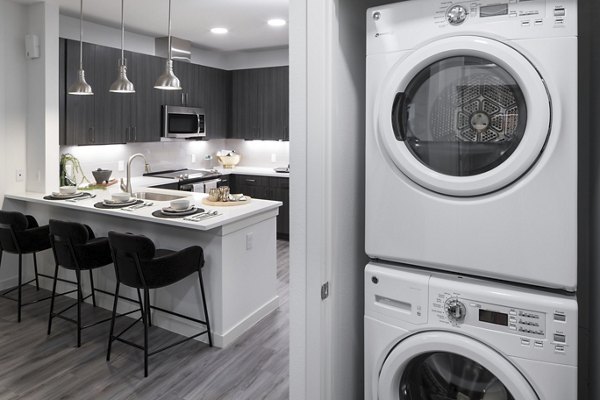 Laundry room with energy-efficient washers and dryers at Alexan Diagonal Crossing Apartments
