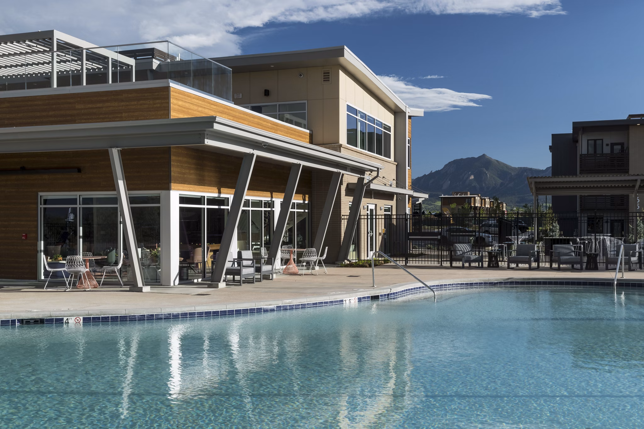 Resort-style pool with shaded lounging at Alexan Diagonal Crossing Apartments