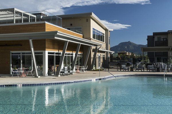 Resort-style pool with shaded lounging at Alexan Diagonal Crossing Apartments