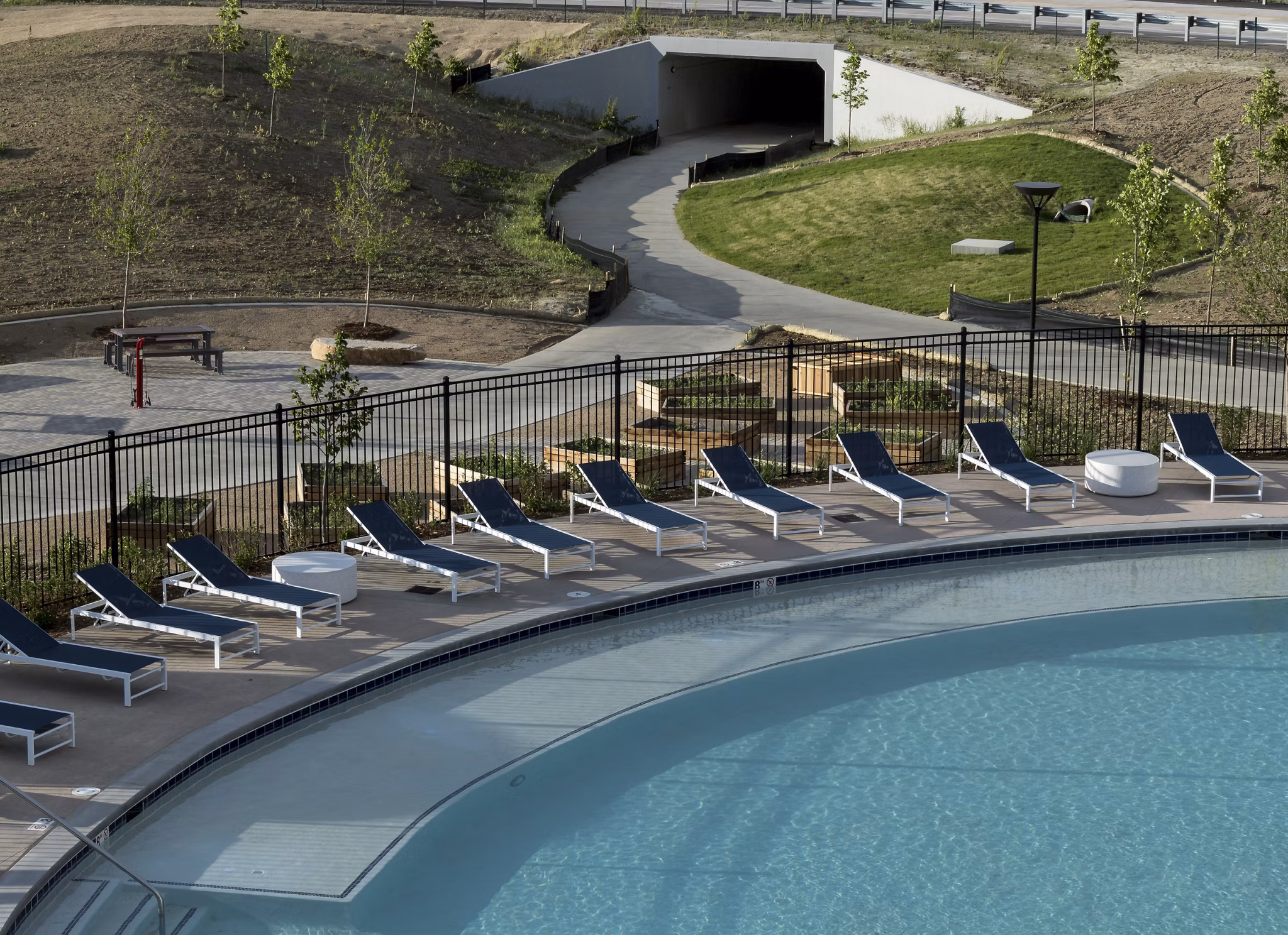 Relaxing outdoor pool area at Alexan Diagonal Crossing Apartments, perfect for leisure and luxury living