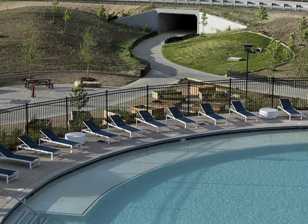 Relaxing outdoor pool area at Alexan Diagonal Crossing Apartments, perfect for leisure and luxury living