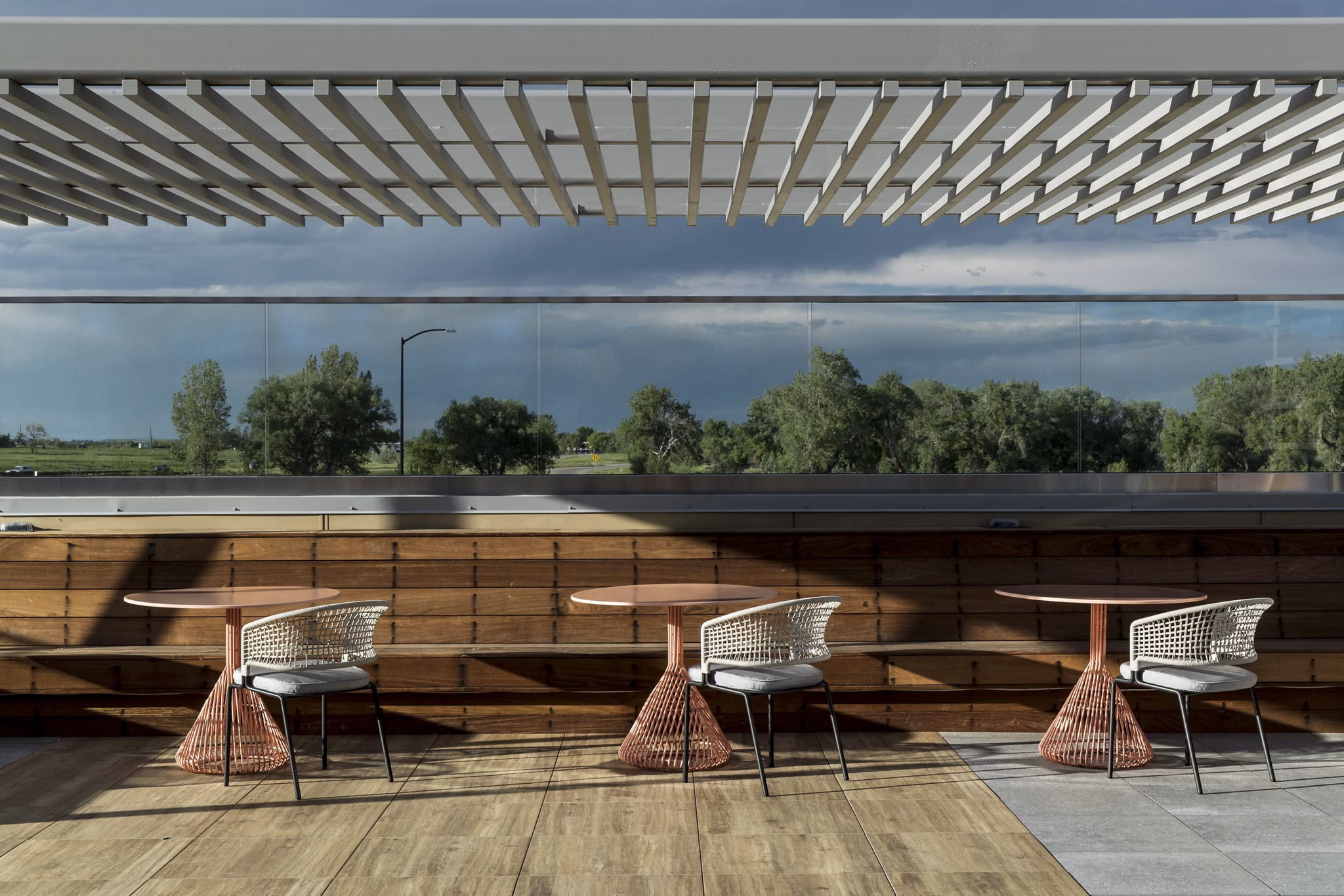 Scenic rooftop deck with modern seating at Alexan Diagonal Crossing Apartments, offering luxury outdoor lounge experience