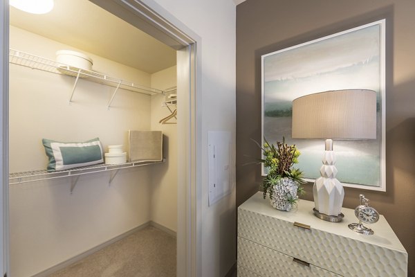 Cozy bedroom featuring stylish decor and large windows at Areum Apartments
