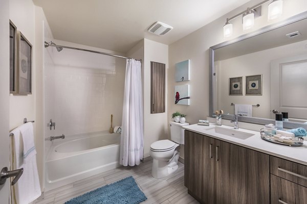 Modern bathroom with sleek fixtures and marble countertop at Areum Apartments