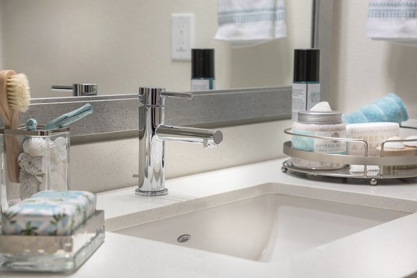 Elegant bathroom with marble accents and spacious shower at Areum Apartments, offering a luxury living experience in a Greystar community