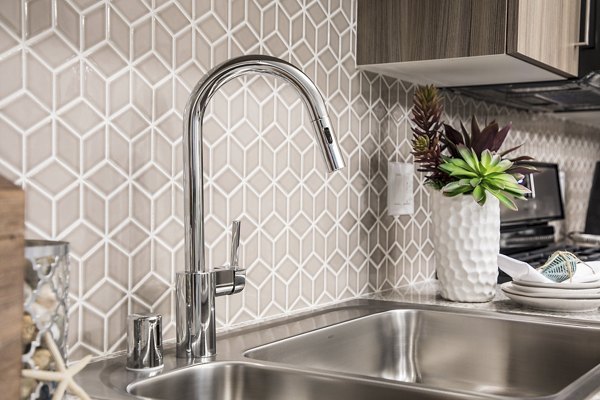kitchen at Areum Apartments with modern appliances and sleek countertops, ideal for culinary experiences in a luxury setting