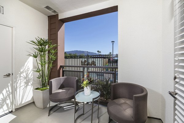 Patio with comfortable seating and lush greenery at Areum Apartments