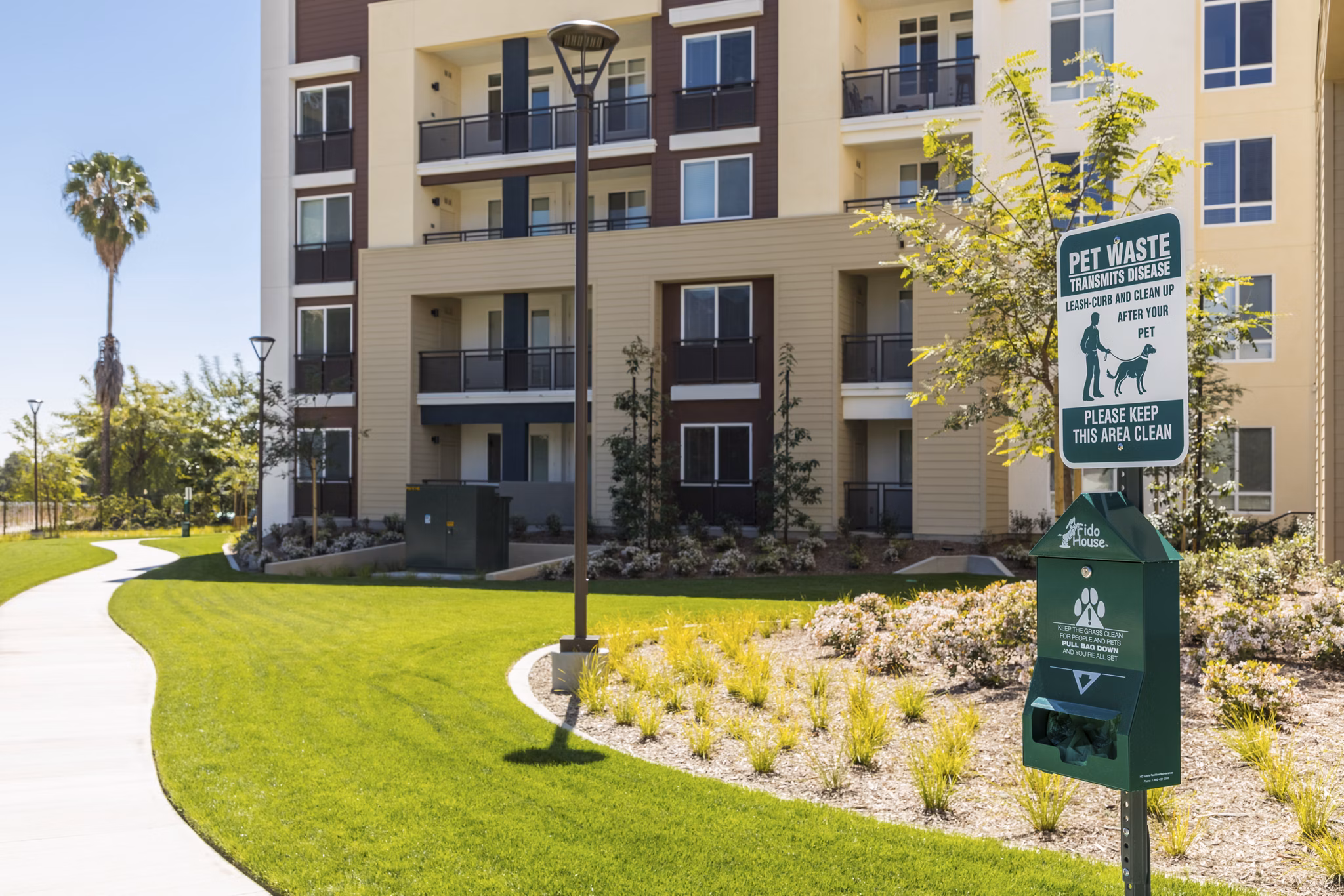 Grass-covered dog park with agility equipment at Areum Apartments perfect for pet-friendly Greystar luxury living