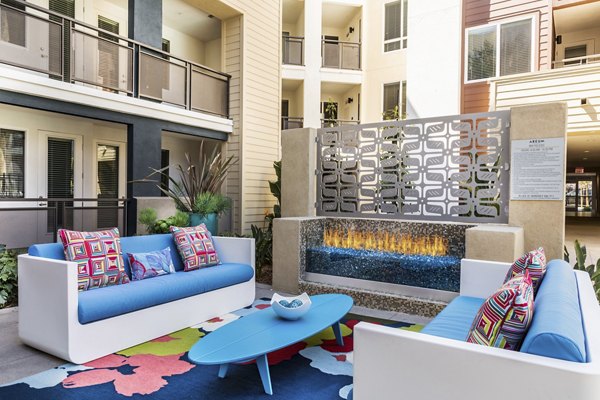 Cozy fire pit at Areum Apartments offering a stylish outdoor gathering area for residents