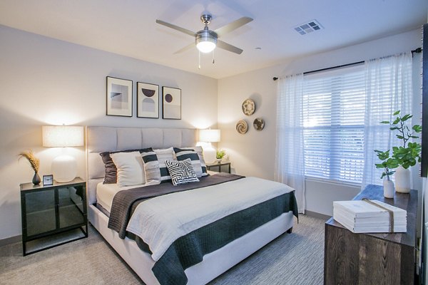 Cozy bedroom with chic decor at Volare Apartments offering luxury living in the heart of the city