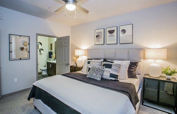 Spacious bedroom featuring modern design and natural light at Volare Apartments