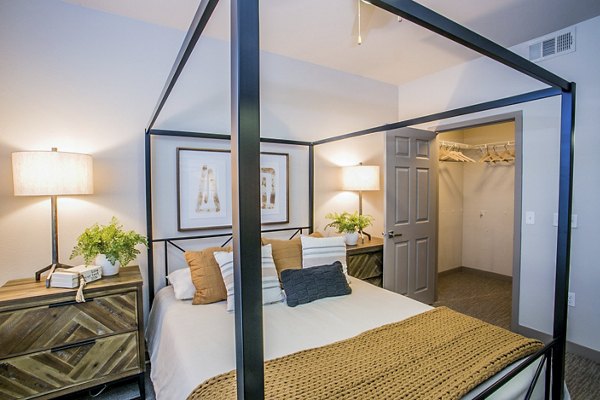 Cozy bedroom with modern decor and natural light at Volare Apartments