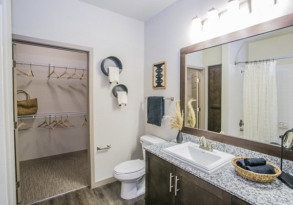 Modern bathroom featuring sleek fixtures and elegant tiles at Volare Apartments, offering a luxurious living experience