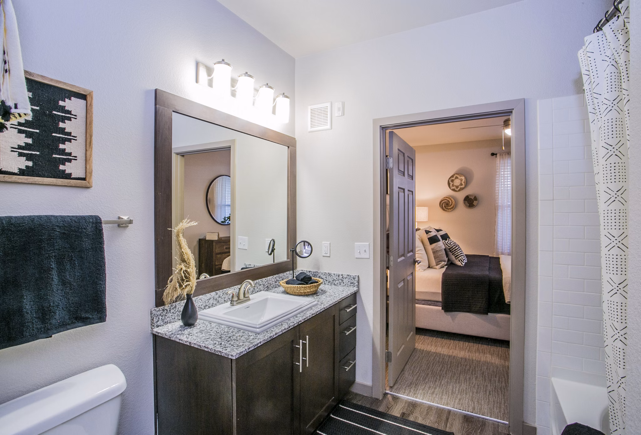 Bathroom featuring modern design and granite countertops at Volare Apartments