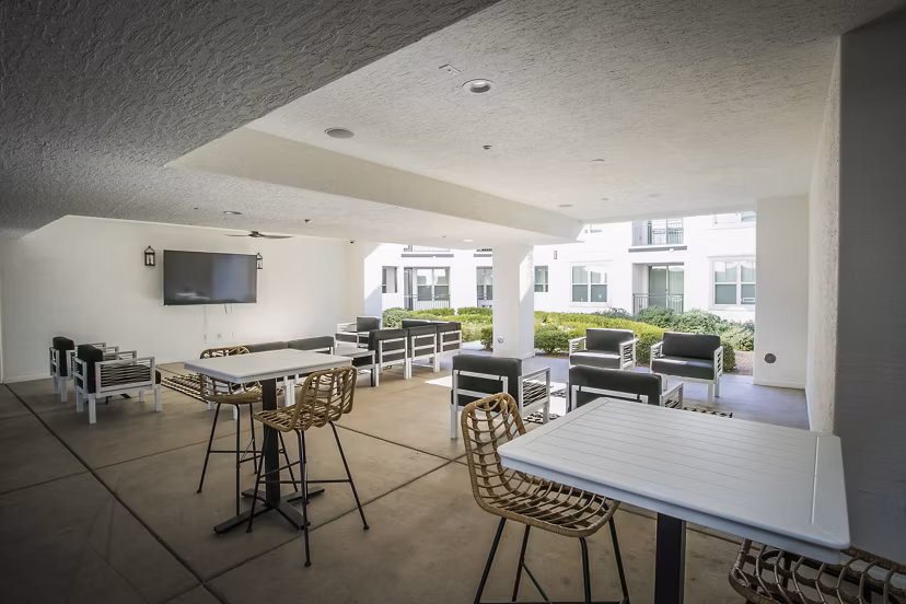 Modern clubhouse with stylish seating and large TV at Volare Apartments, luxury property offering upscale living in prime location