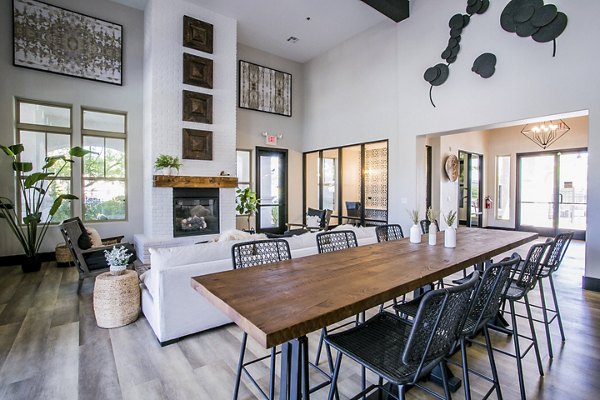 Modern clubhouse with stylish seating and large TV at Volare Apartments, luxury property offering upscale living in prime location