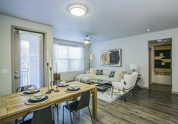 Elegant dining area with modern furnishings in Volare Apartments, ideal for hosting gatherings and enjoying gourmet meals