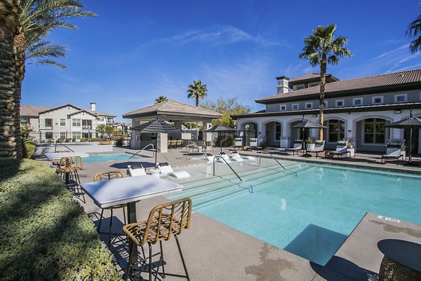 Resort-style pool with lounge areas at Volare Apartments, luxury living in scenic surroundings