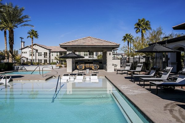 Resort-style pool with lush landscaping at Volare Apartments, luxury living in a serene setting