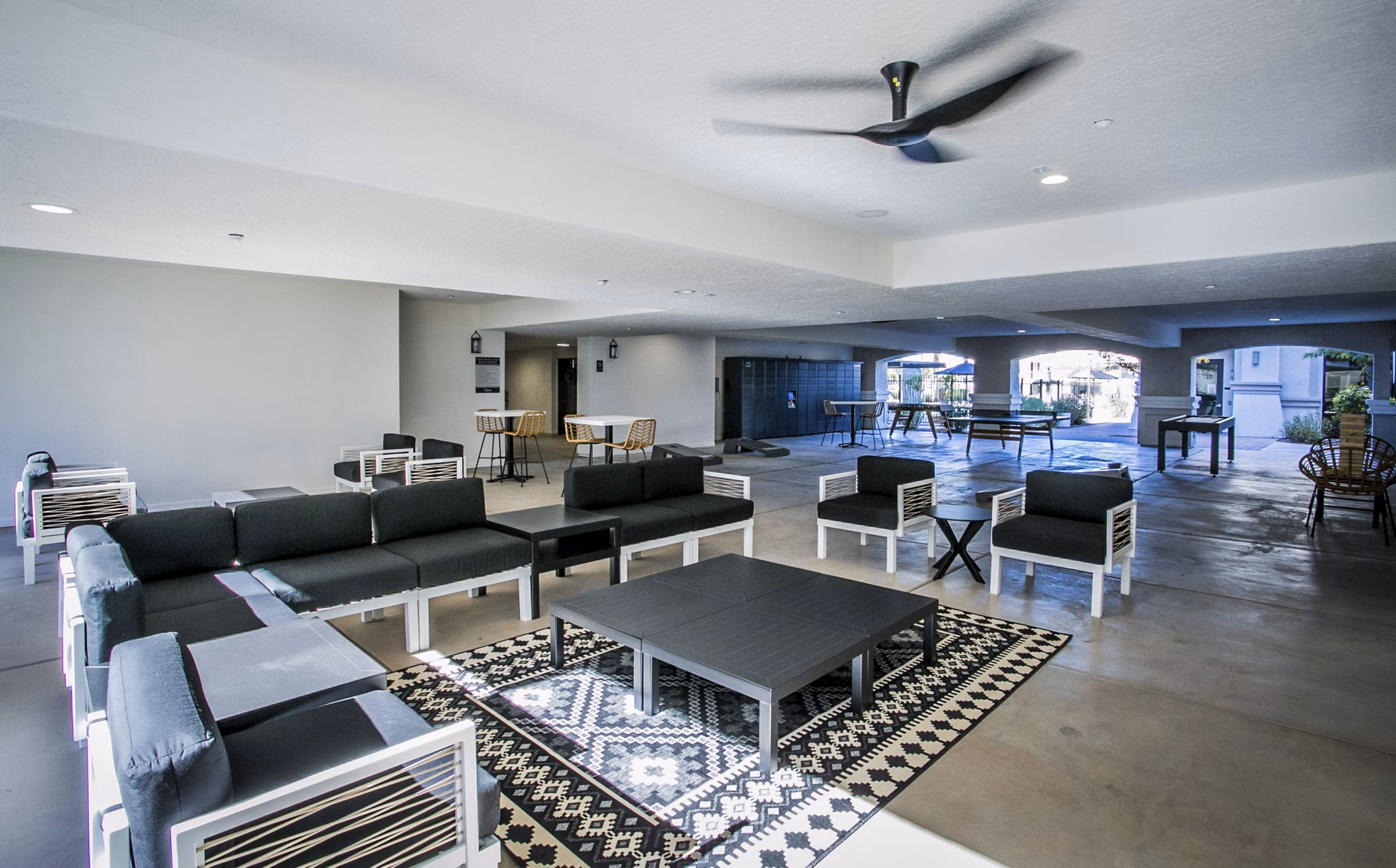 Spacious outdoor patio with seating and greenery at Volare Apartments in Greystar's luxury community