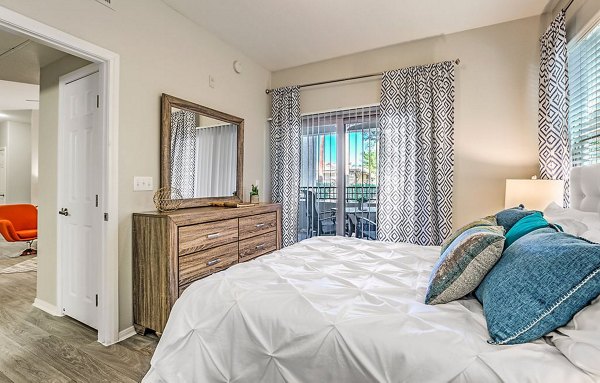 Modern bedroom with elegant decor and large windows at Luminous Apartments