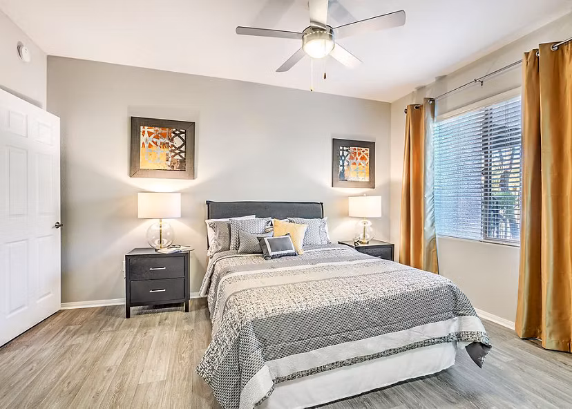 Modern bedroom with designer furnishings at Luminous Apartments, offering luxury living by Greystar in a serene setting