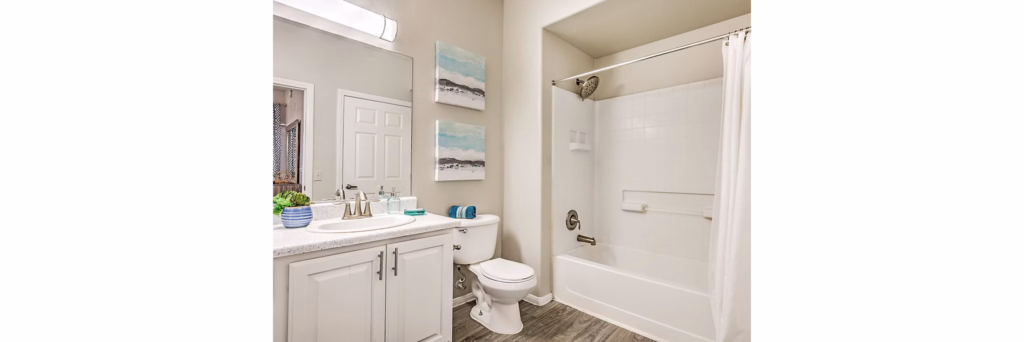 Modern bathroom with sleek fixtures and large mirror in Luminous Apartments