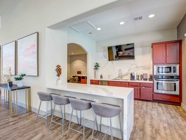 Stylish clubhouse with modern decor at Luminous Apartments, ideal for social gatherings and leisure activities