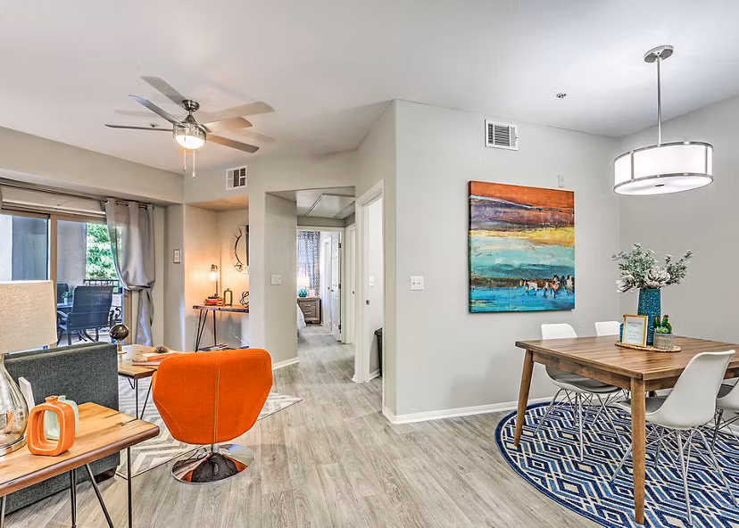 Dining room with elegant chandelier and modern decor at Luminous Apartments in Greystar luxury collection