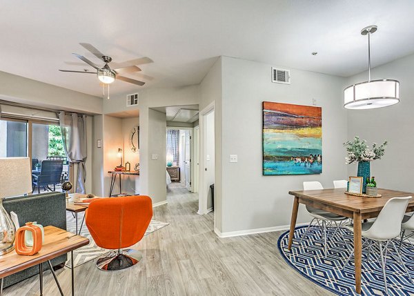 Dining room with elegant chandelier and modern decor at Luminous Apartments in Greystar luxury collection