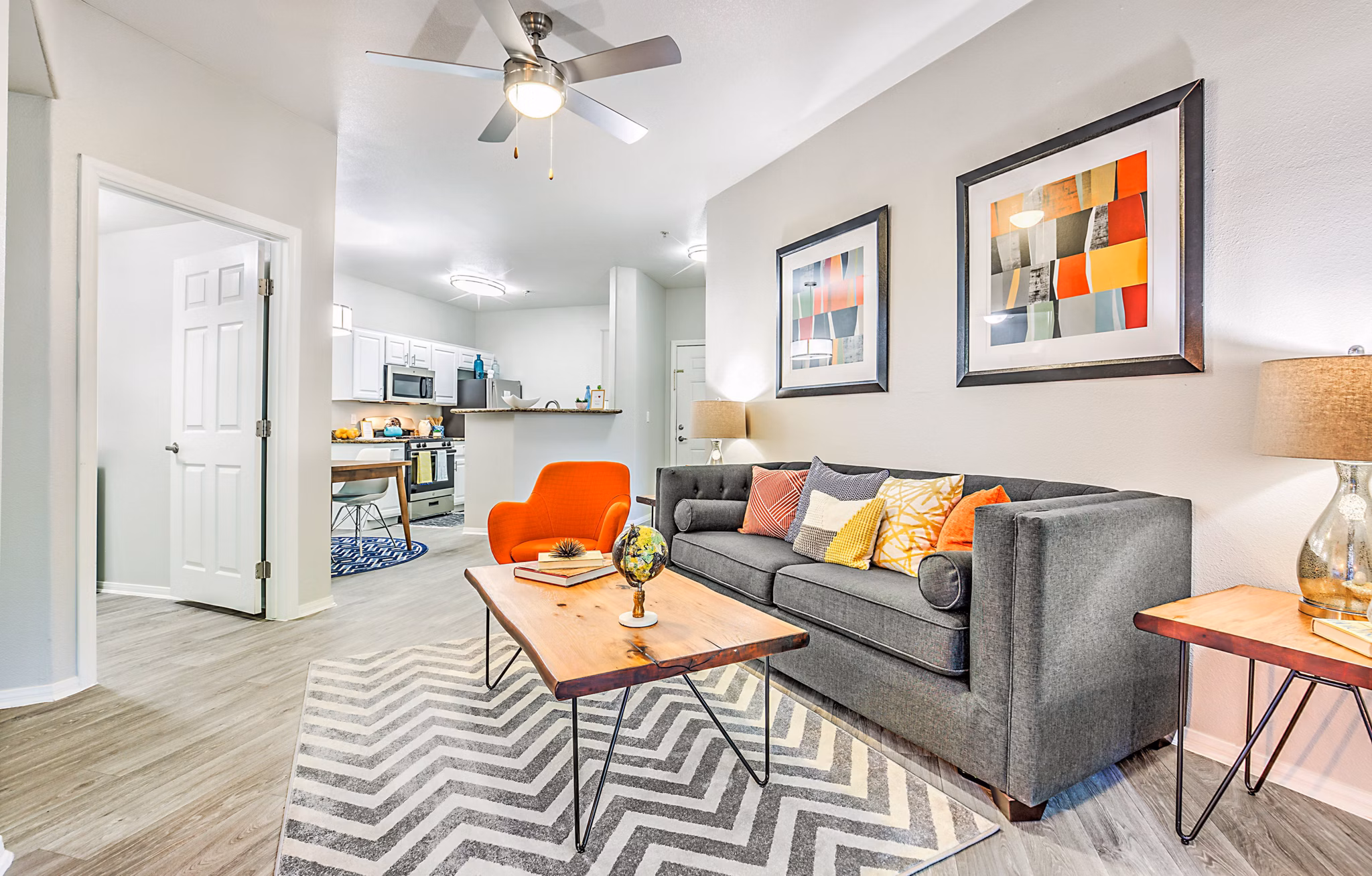Living room with modern furnishings and large windows at Luminous Apartments offering luxury Greystar living experience