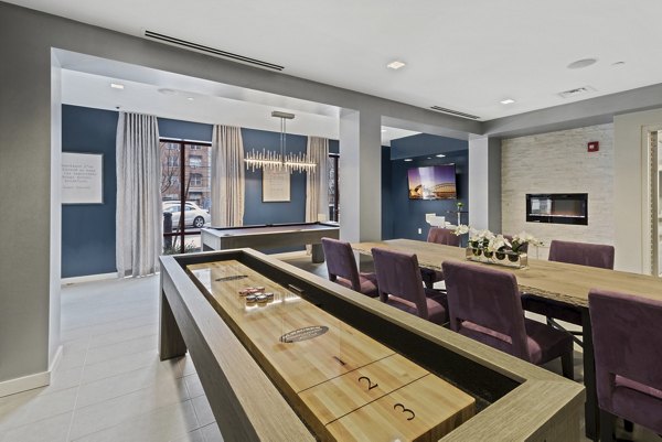 Clubhouse featuring modern lounge areas at The Quincy Apartments luxury living
